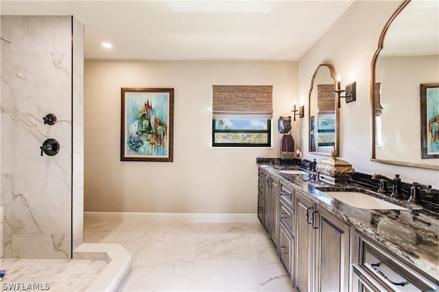 bathroom with vanity and a tile shower