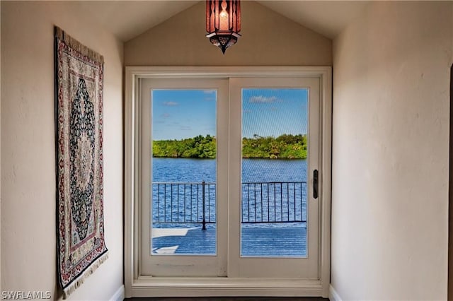 doorway to outside featuring a water view and lofted ceiling