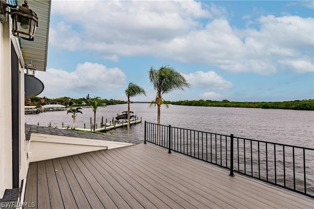 wooden terrace with a boat dock and a water view