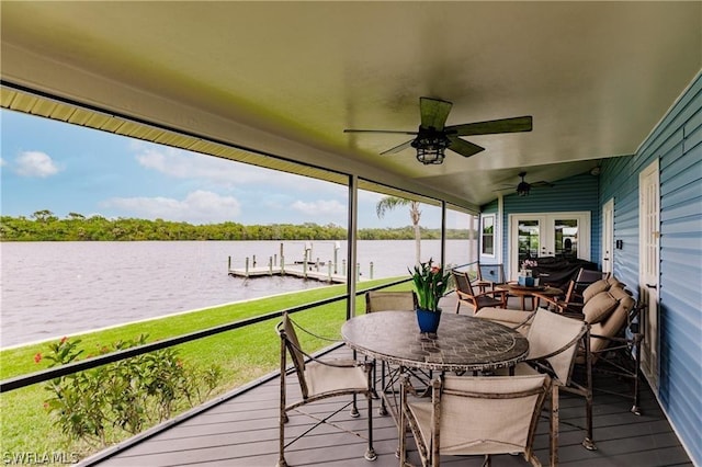 sunroom with french doors, a water view, ceiling fan, and lofted ceiling