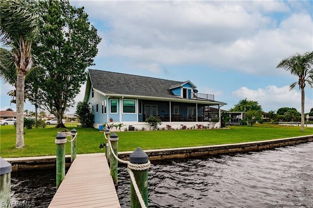 dock area featuring a water view and a yard