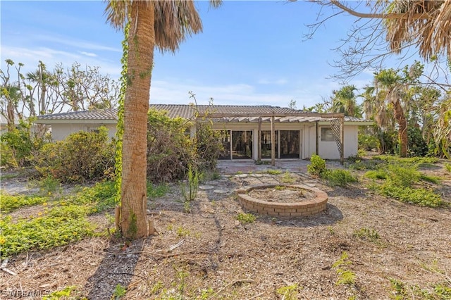 back of property with a pergola