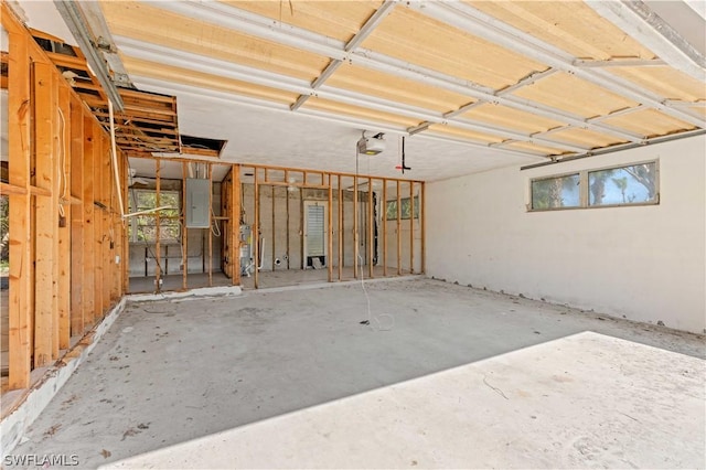 garage featuring electric panel and a garage door opener