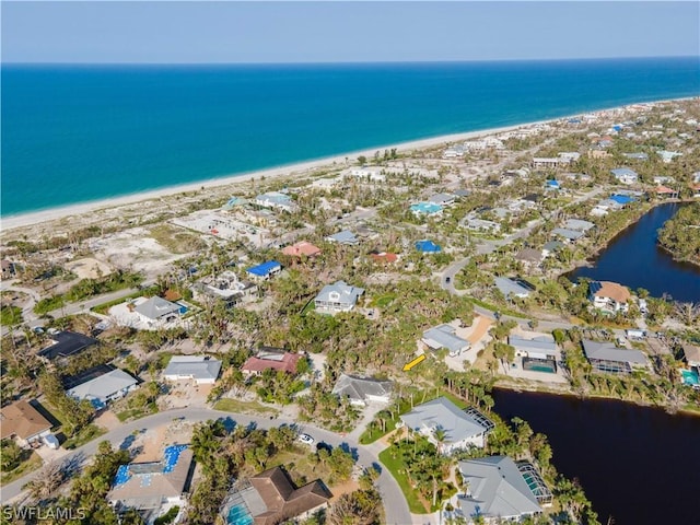 bird's eye view with a beach view and a water view