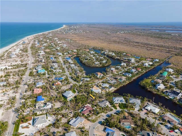 birds eye view of property featuring a beach view and a water view