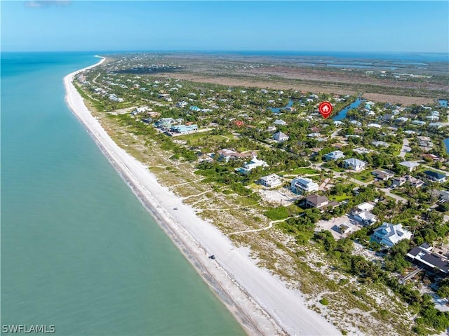 birds eye view of property with a view of the beach and a water view