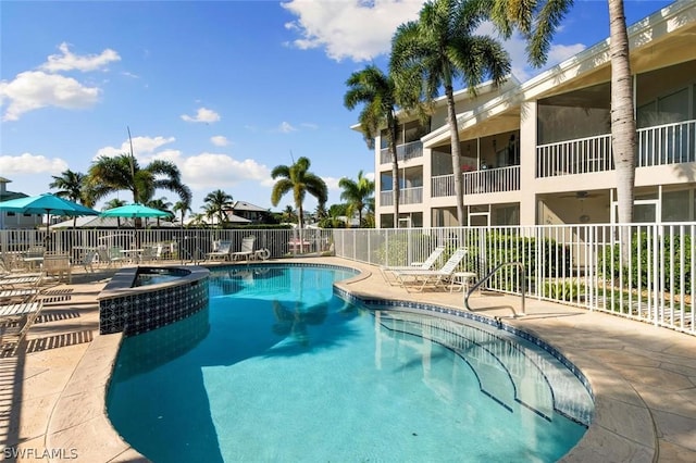 view of swimming pool with a community hot tub and a patio