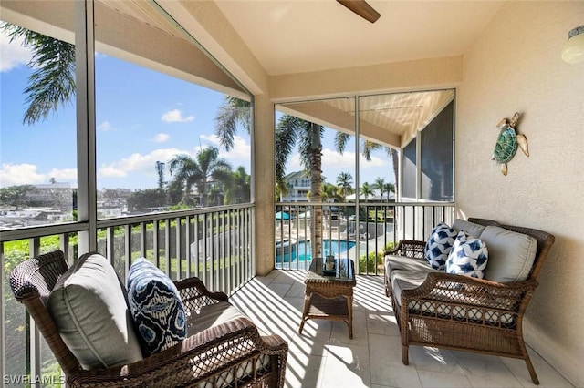 sunroom featuring a ceiling fan