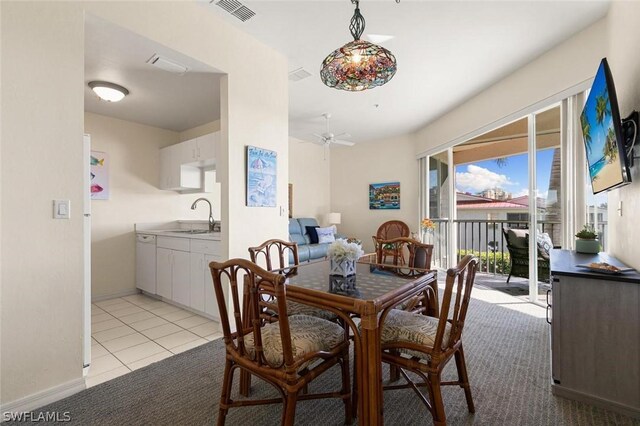 tiled dining room with sink and ceiling fan