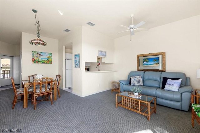 living room featuring dark colored carpet and ceiling fan