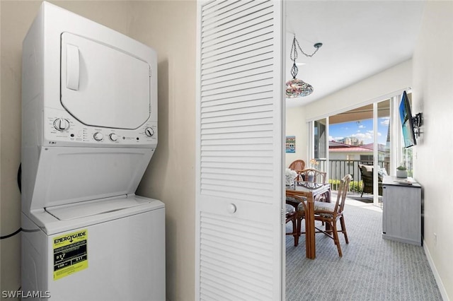 laundry area featuring stacked washer and clothes dryer