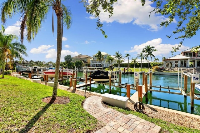 dock area with a yard and a water view