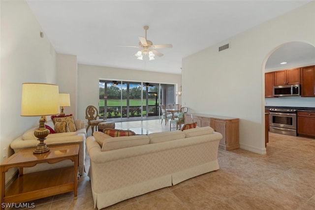 tiled living room with ceiling fan