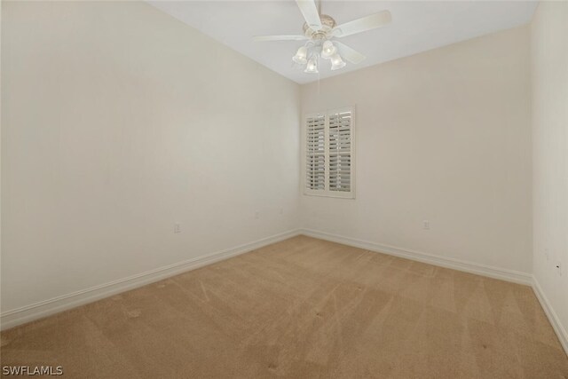 carpeted spare room with ceiling fan