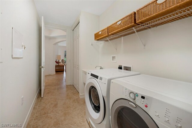 washroom with independent washer and dryer and light tile patterned floors