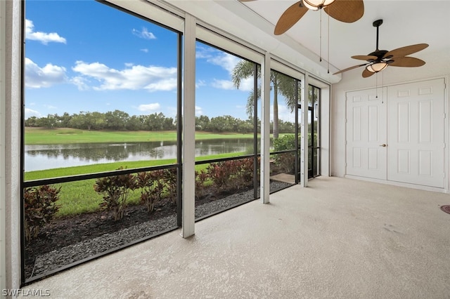 unfurnished sunroom featuring a water view and ceiling fan