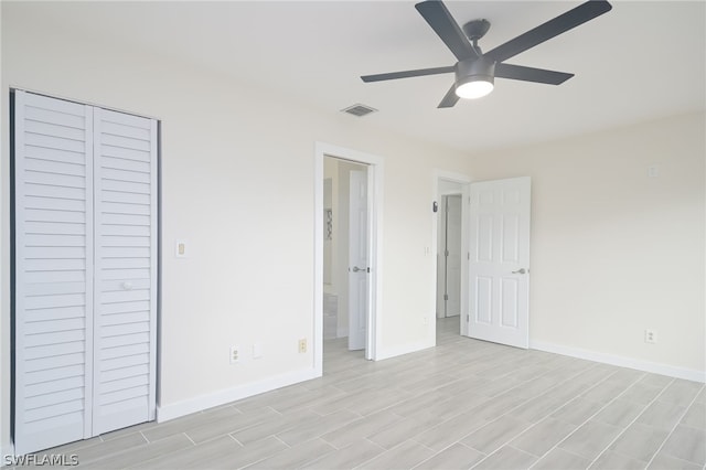 unfurnished bedroom featuring ceiling fan and a closet