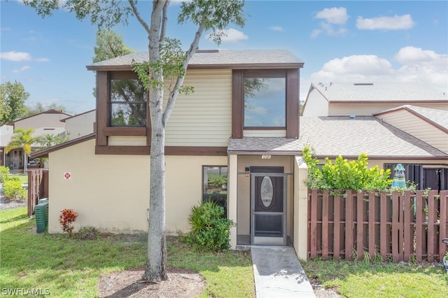 view of front of house with a front yard and central AC