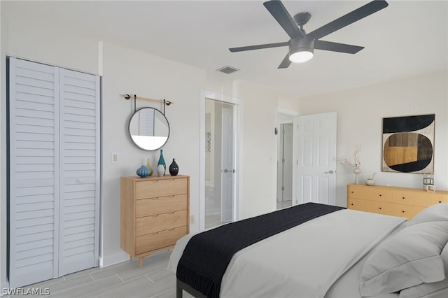 bedroom with ceiling fan and a closet