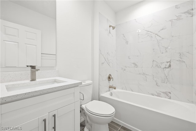 full bathroom featuring tiled shower / bath, oversized vanity, tile flooring, and toilet