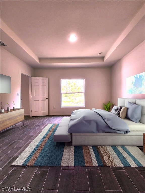 bedroom with dark wood-type flooring and a tray ceiling