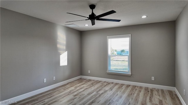 unfurnished room with ceiling fan and light hardwood / wood-style floors