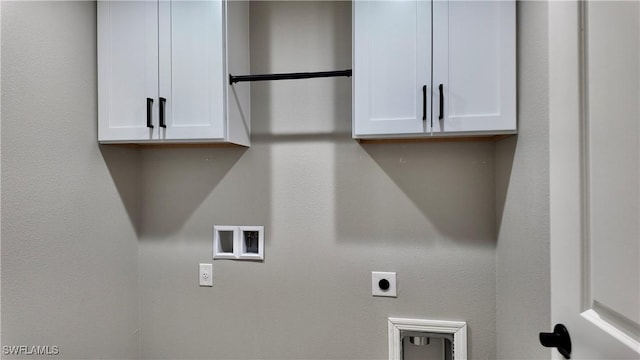 clothes washing area with electric dryer hookup, cabinets, and hookup for a washing machine