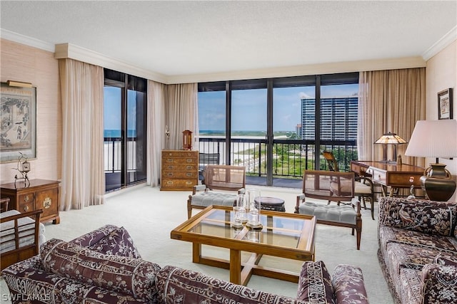 carpeted living room with crown molding, a water view, a textured ceiling, and a wall of windows