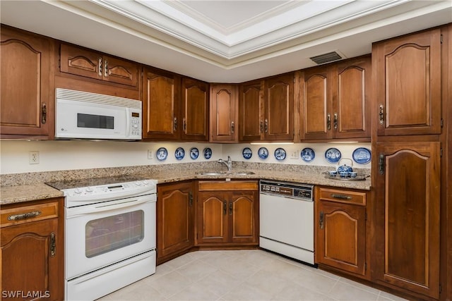 kitchen featuring light stone counters, white appliances, sink, and ornamental molding