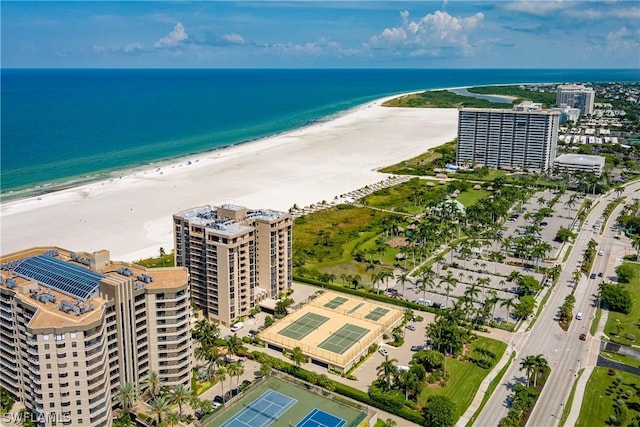 drone / aerial view featuring a water view and a beach view