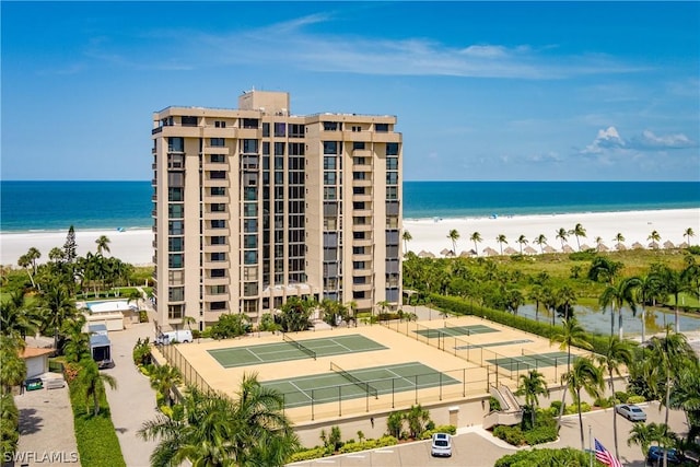 view of property featuring a water view and a beach view