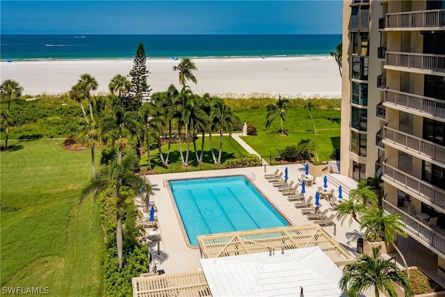 view of pool with a view of the beach and a water view