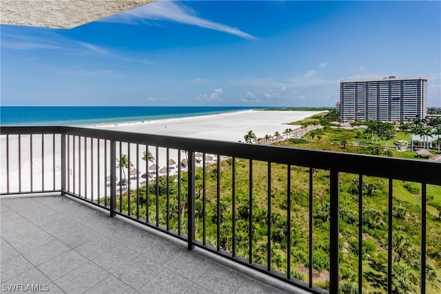 balcony with a beach view and a water view