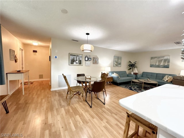 dining space with light hardwood / wood-style floors