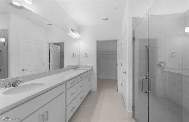 bathroom with vanity, walk in shower, and tile patterned floors