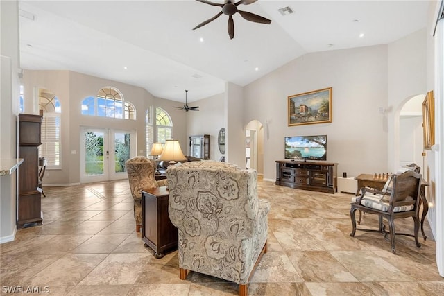 living room with ceiling fan, french doors, and high vaulted ceiling