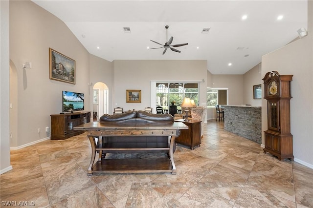 living room featuring ceiling fan and vaulted ceiling