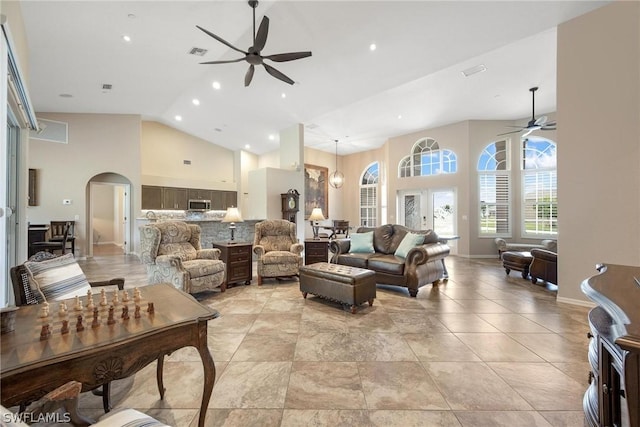 living room with ceiling fan and high vaulted ceiling