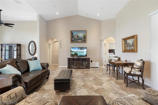 living room with ceiling fan and high vaulted ceiling