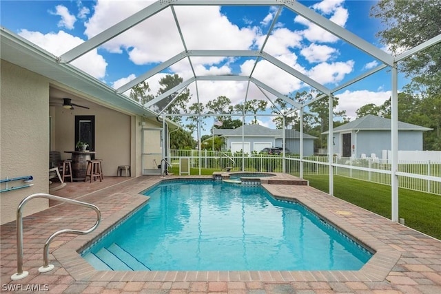 view of pool with glass enclosure, a patio area, an in ground hot tub, and ceiling fan