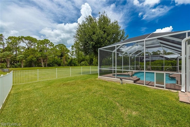 view of yard with glass enclosure and a swimming pool with hot tub