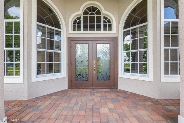 view of exterior entry featuring french doors