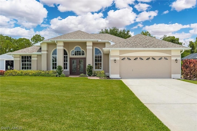 view of front facade featuring a front yard, french doors, and a garage