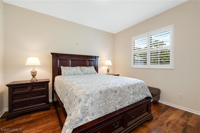 bedroom with dark wood-type flooring