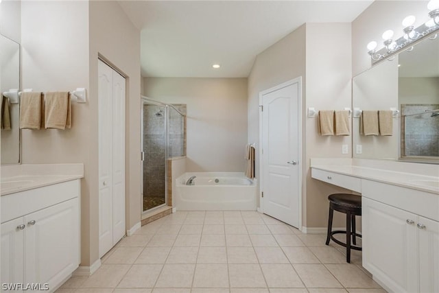 bathroom with plus walk in shower, vanity, and tile patterned flooring