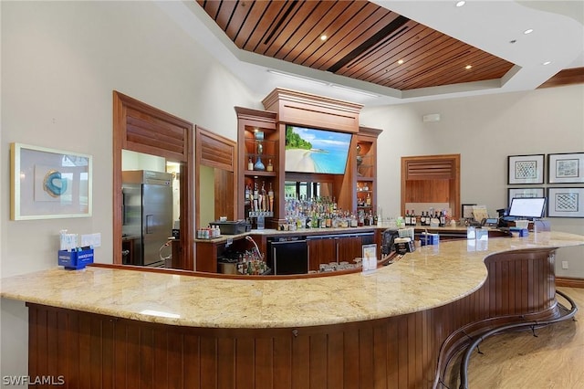 bar with stainless steel fridge with ice dispenser, light wood-type flooring, wood ceiling, and a tray ceiling