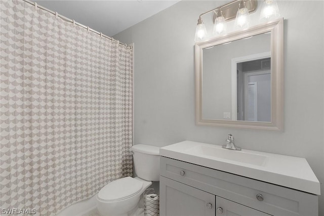 bathroom featuring toilet, a shower with curtain, and vanity