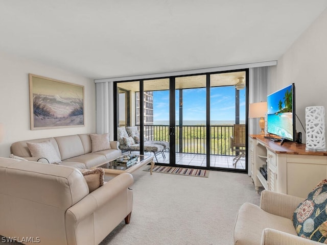 carpeted living room featuring floor to ceiling windows