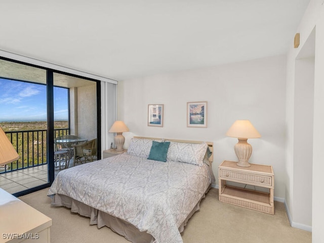 bedroom with light colored carpet, access to exterior, and a wall of windows