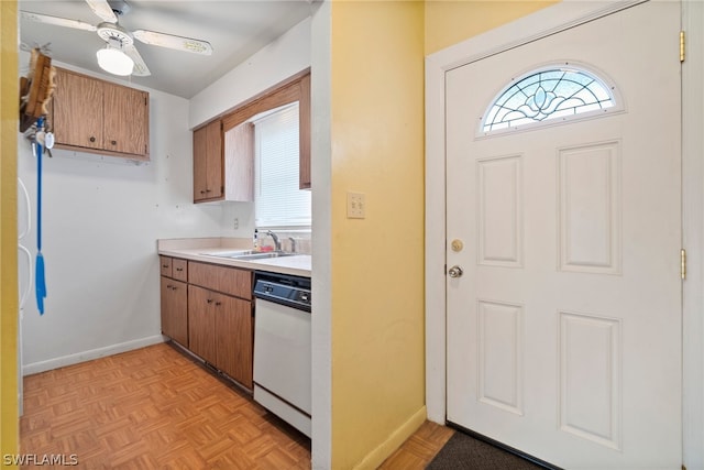 kitchen with sink, light parquet floors, dishwasher, and ceiling fan